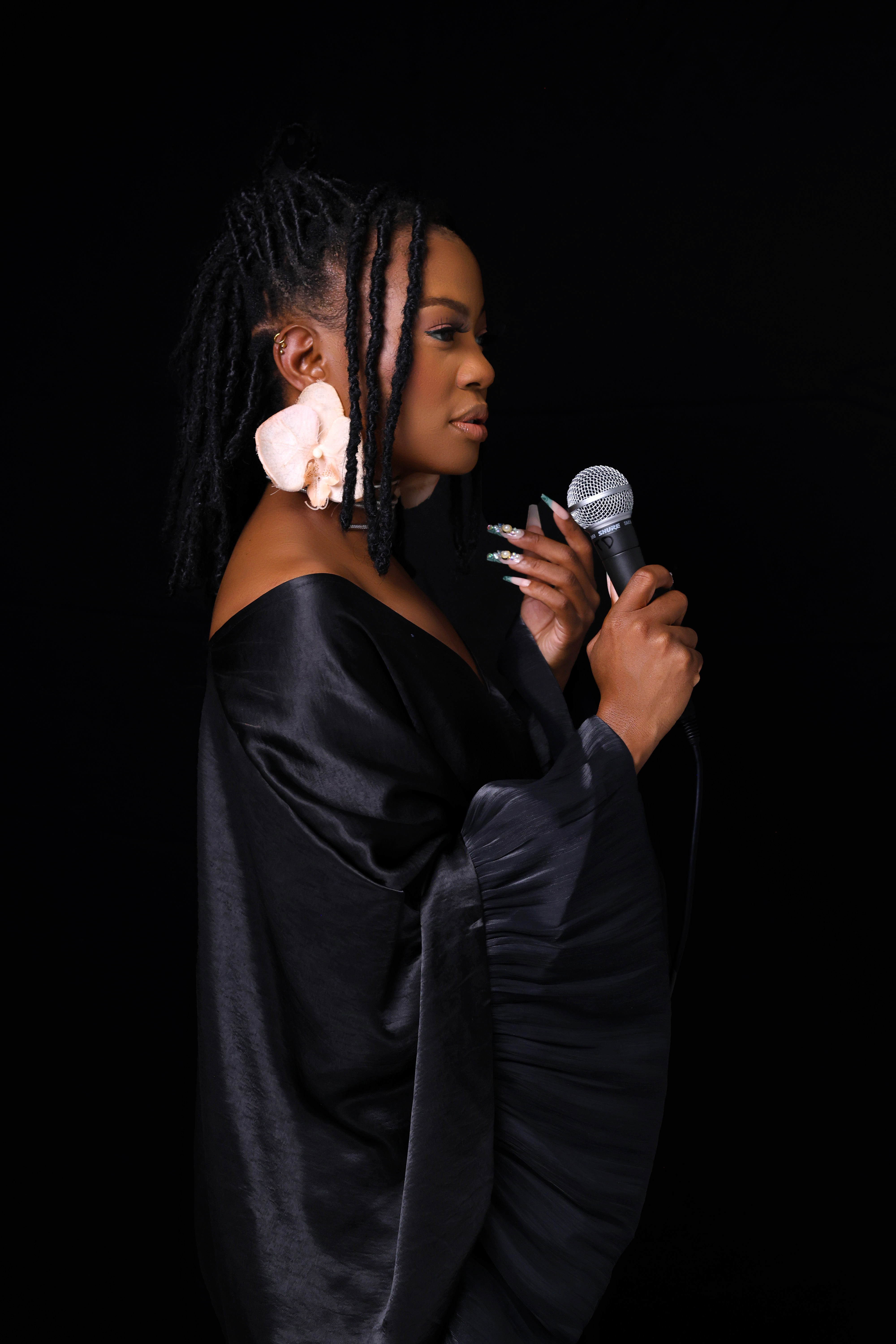 Studio portrait of a performer holding a microphone